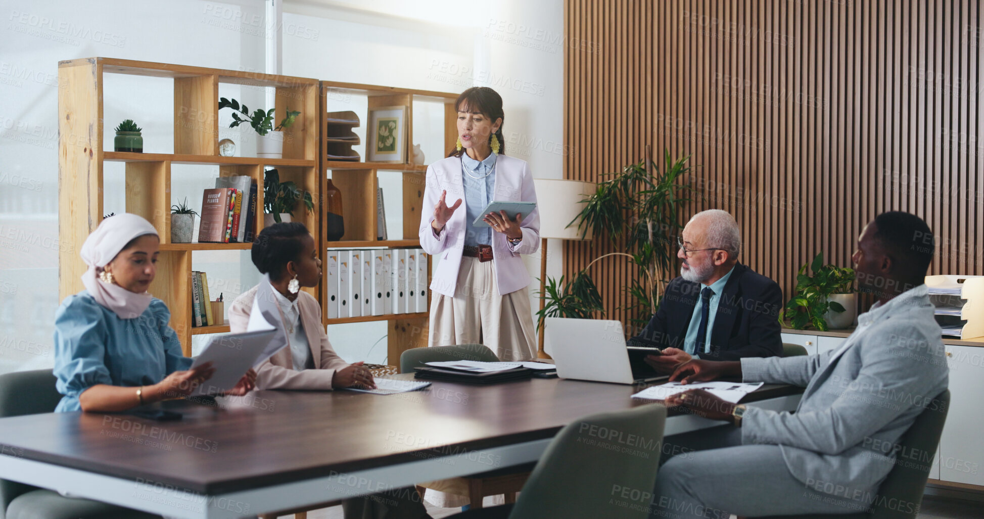 Buy stock photo Woman, tablet and review with team in office meeting on app with planning, insight or talk at insurance company. Person, speaker and tech for group, feedback or risk management report at agency