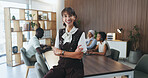 Woman, happy and arms crossed at meeting with team, confidence and pride at media company. Person, journalist or editor in office with smile, group or leader in boardroom for portrait at press agency