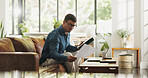 Document, remote work and man with tablet in house for account manager, client portfolio and research. Admin, feedback and paperwork with person in living room for planning or reading in home office