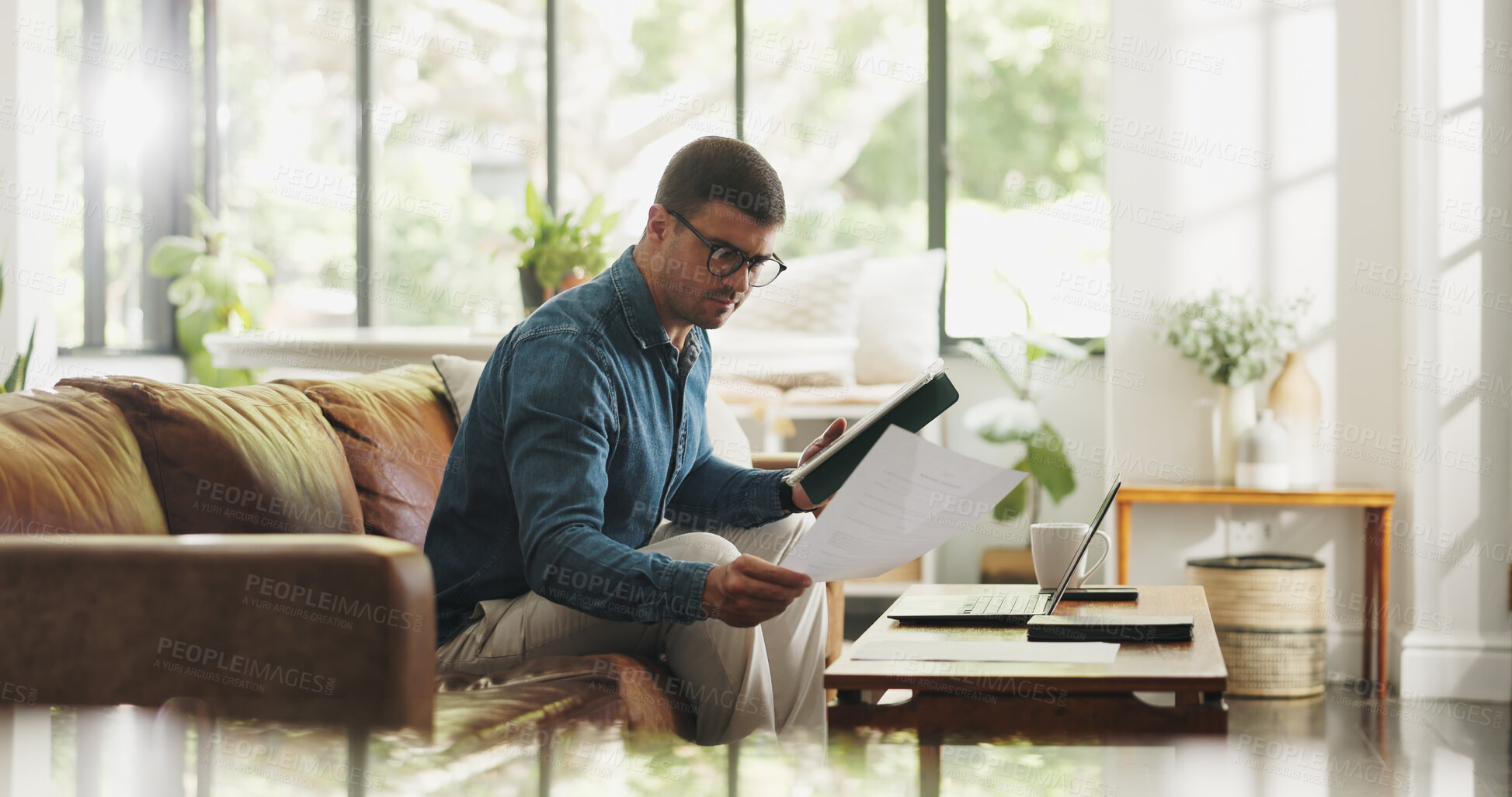 Buy stock photo Document, remote work and man with tablet in house for account manager, client portfolio and research. Admin, feedback and paperwork with person in living room for planning or reading in home office