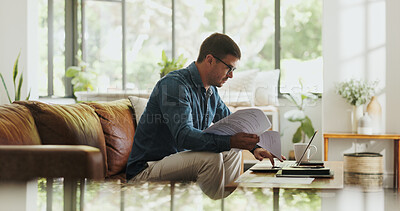 Buy stock photo Paperwork, remote work and man with laptop in home office for account manager, client portfolio and research. Admin, feedback and networking with person in living room for planning or typing in house