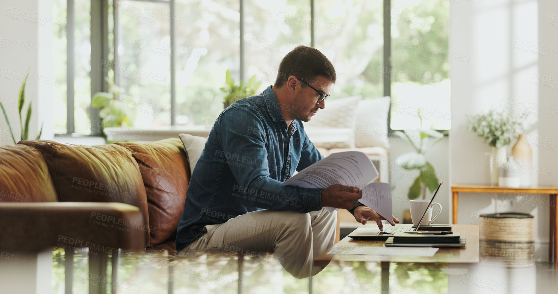 Buy stock photo Paperwork, remote work and man with laptop in home office for account manager, client portfolio and research. Admin, feedback and networking with person in living room for planning or typing in house