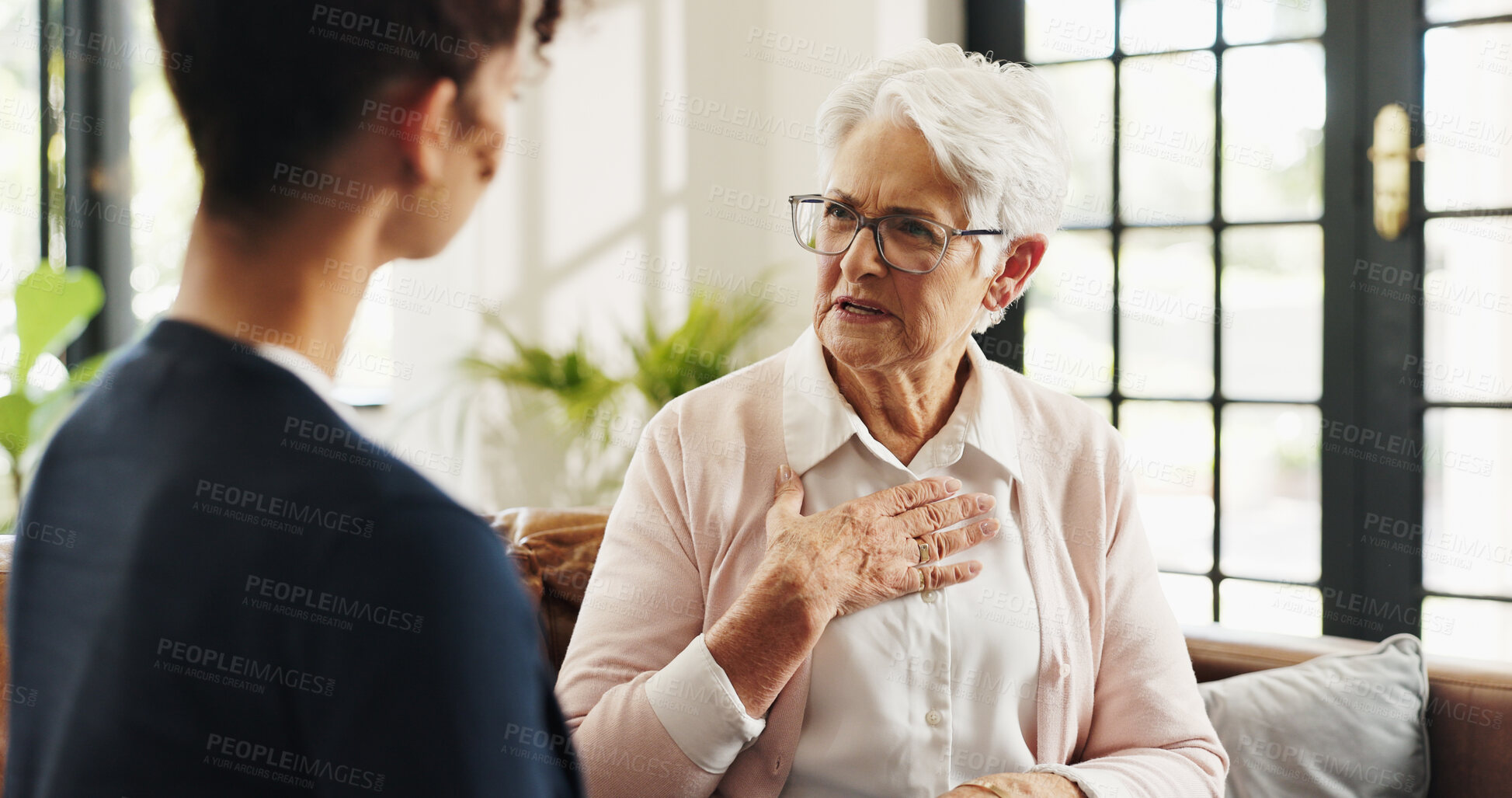 Buy stock photo Conversation, volunteer and senior woman in home for rehabilitation, checkup and post surgery recovery. Apartment, pensioner or elderly person in living room for support, chat and advice for help