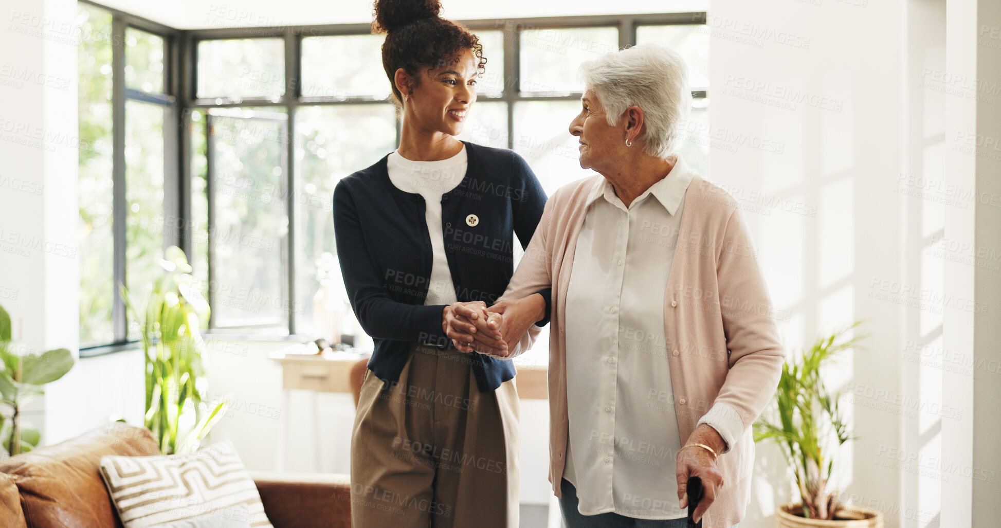 Buy stock photo Nurse, old woman and help with walking stick in home for mobility, smile and support in retirement. Patient, caregiver and elderly person with disability, cane or holding hands for rehabilitation
