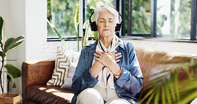 Buy stock photo Old woman, headphones and meditation on couch in home, sound or streaming service in lounge. Senior person, smile and listen to music with subscription, audio and eyes closed on sofa in retirement