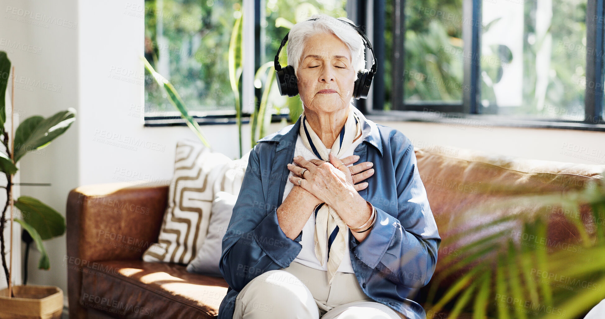 Buy stock photo Old woman, headphones and meditation on couch in home, sound or streaming service in lounge. Senior person, smile and listen to music with subscription, audio and eyes closed on sofa in retirement