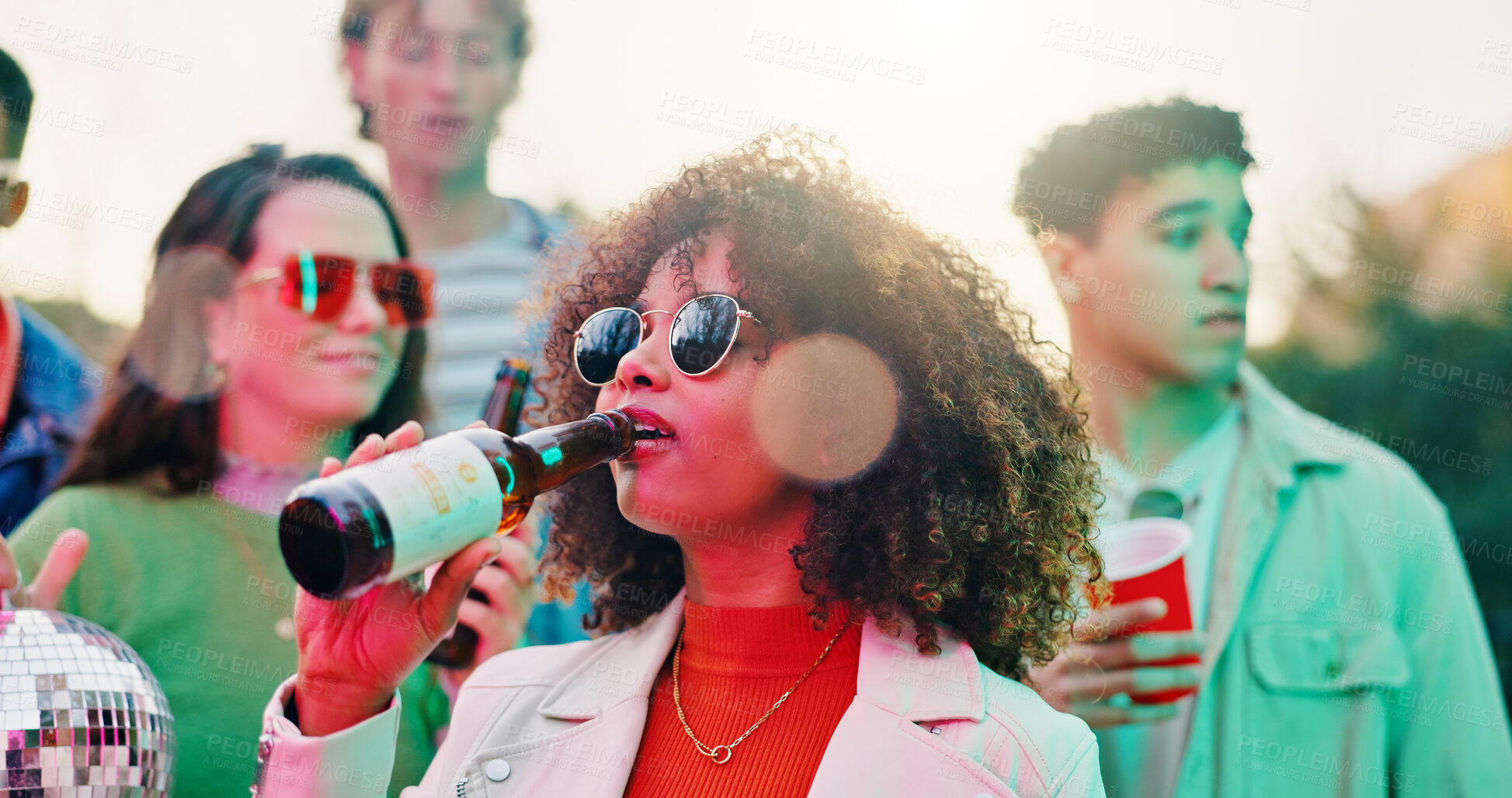 Buy stock photo Outdoor, friends and woman with beer at party, disco ball or social gathering for weekend celebration. Hang out, reunion event and people with alcohol beverage for fun, rave and drinking together