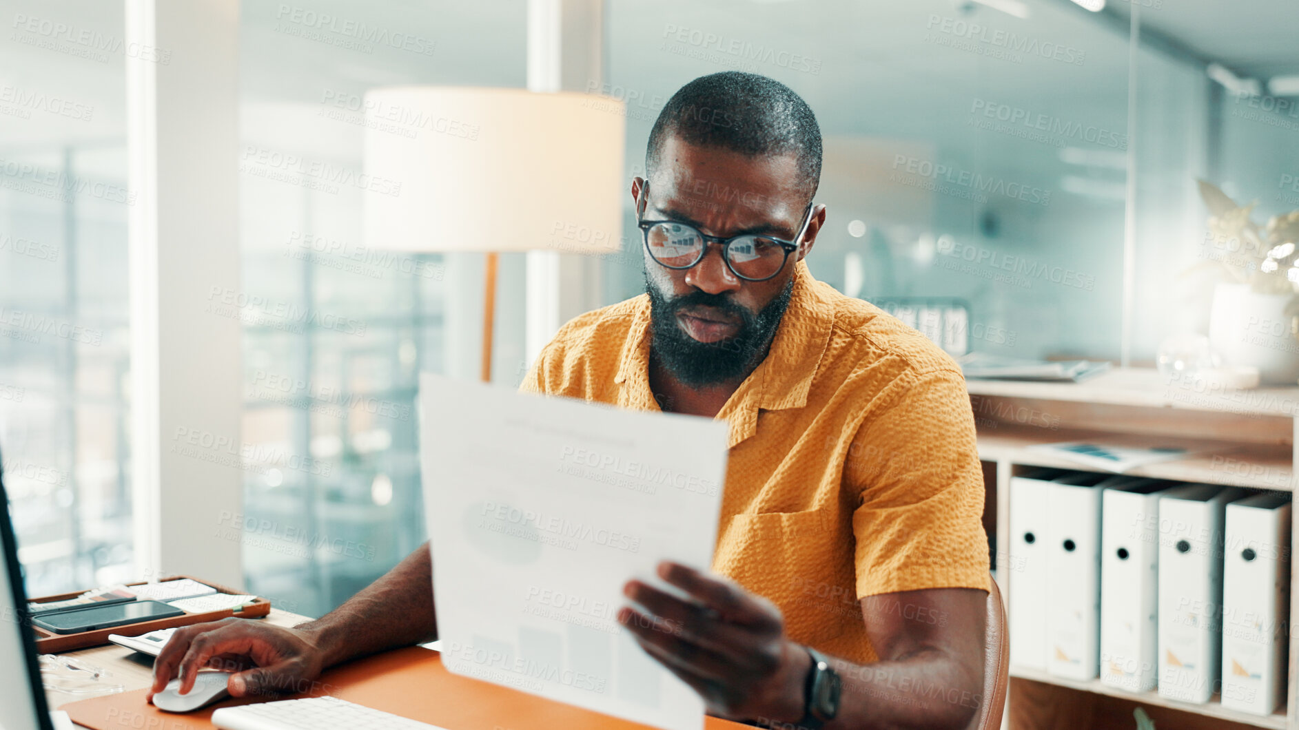 Buy stock photo Creative agency, reading and black man in office, documents for sales report and charts for revenue. African person, employee and professional with paperwork, planning and review for profit growth