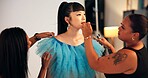Getting ready, makeup and photography team with model in studio for behind the scenes styling. Cosmetics, lipstick and preparation with women on set together film, media or photoshoot production