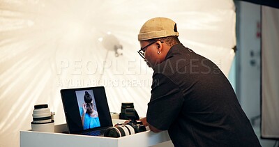 Buy stock photo Photographer, man and laptop with screen in studio for catalog results, editing or creative process. Cameraman, black person and tech display BTS for photoshoot review, color grading or retouch image