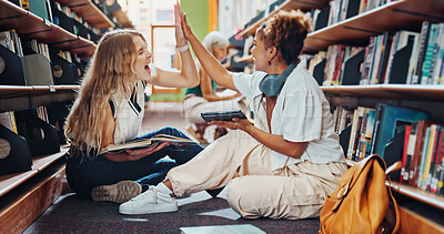 Buy stock photo Tablet, women and students in library, high five for project completion and application approval. Success, friends or people on floor, smile or tech for test results, scholarship award or celebration