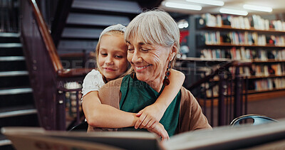 Buy stock photo Book, hug and library with student and teacher on floor together for learning or literature. Development, education and reading with happy girl child embracing mature woman for growth in school