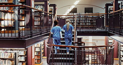Buy stock photo Medical, students and women in library for education, learning and girls walk on stairs in college. University, nurses and friends on steps for healthcare, scholarship and back for development