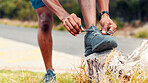 Man, fitness and tying with sneakers on log for workout preparation or outdoor exercise in nature. Active, male person or getting ready with hands, tie or shoes for training, hiking or trekking