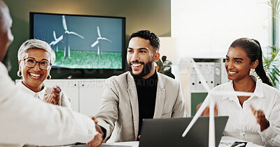Buy stock photo Man, handshake and success at office meeting with windmill model, happy and deal for sustainable business. People, team and excited with eco friendly electricity, goal and renewable energy at agency