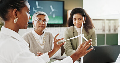 Buy stock photo Woman, team and discussion at office meeting with windmill model, planning and insight for sustainable business. People, wind turbine and feedback for electricity, talk or renewable energy at agency