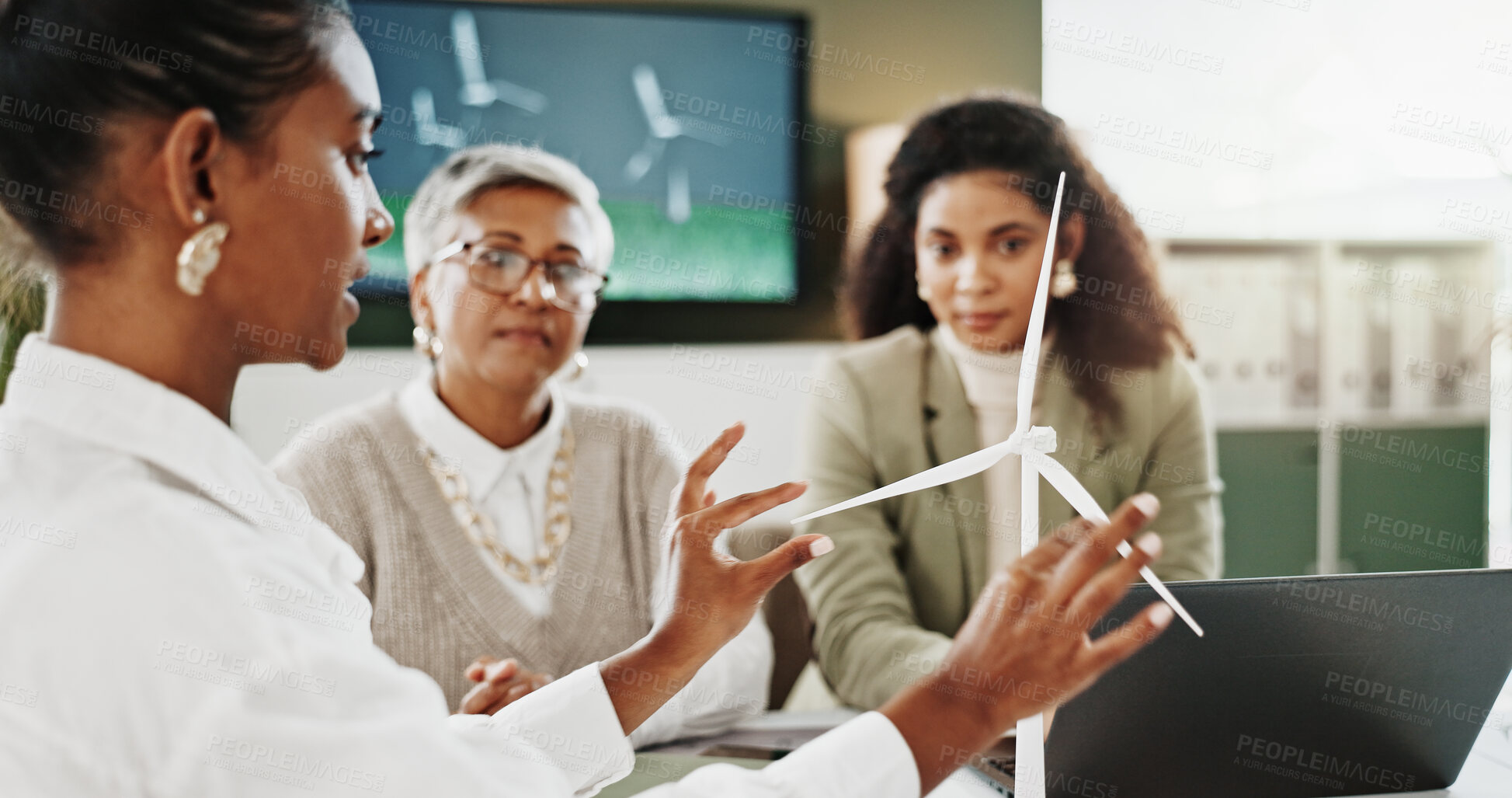 Buy stock photo Woman, team and discussion at office meeting with windmill model, planning and insight for sustainable business. People, wind turbine and feedback for electricity, talk or renewable energy at agency