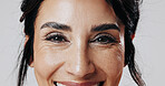 Smile, woman and eyes with makeup in studio for beauty, laminated eyebrows and natural glow. Portrait, mature person and cosmetics with lash extension, facial treatment and change on white background