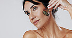 Woman, jade roller and thinking with skincare in studio, circulation or mockup space on white background. Mature person, stone tools and cosmetics with benefits, lymphatic drainage and dermatology
