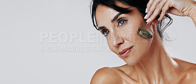 Buy stock photo Woman, jade roller and thinking with beauty in studio, circulation or mockup space on white background. Mature person, stone tools and skincare with benefits, lymphatic drainage and dermatology