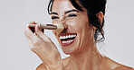 Woman, makeup brush and laugh in studio portrait for beauty, powder and application on white background. Mature person, cosmetics and tools for foundation on nose, playful and smile in New Zealand