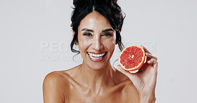 Buy stock photo Happy woman, portrait and skincare with grapefruit in studio for health on a white background. Female person, mature or smile with natural organic fruit for anti aging diet, vitamin C or antioxidants