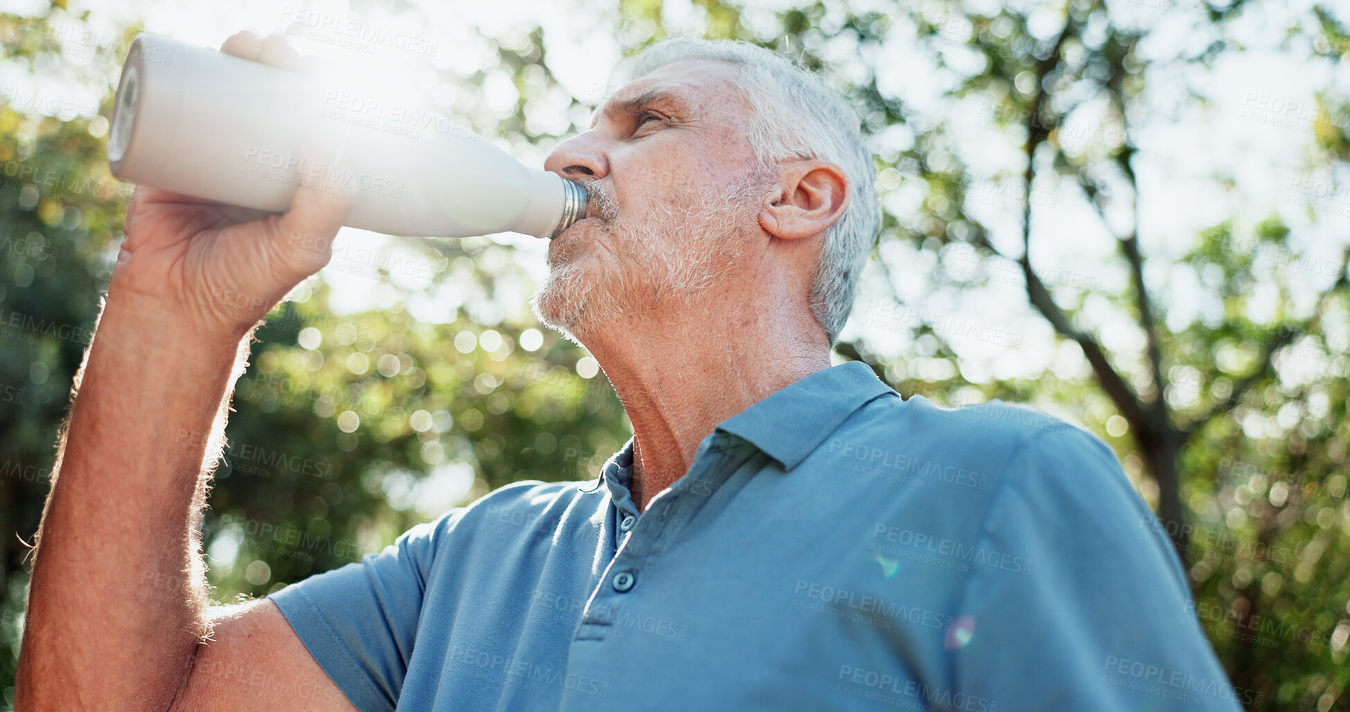 Buy stock photo Exercise, drinking water and old man in garden, low angle and workout for health benefits, Outdoor, detox and elderly person in backyard, hydration and thirsty for liquid, fitness and retirement
