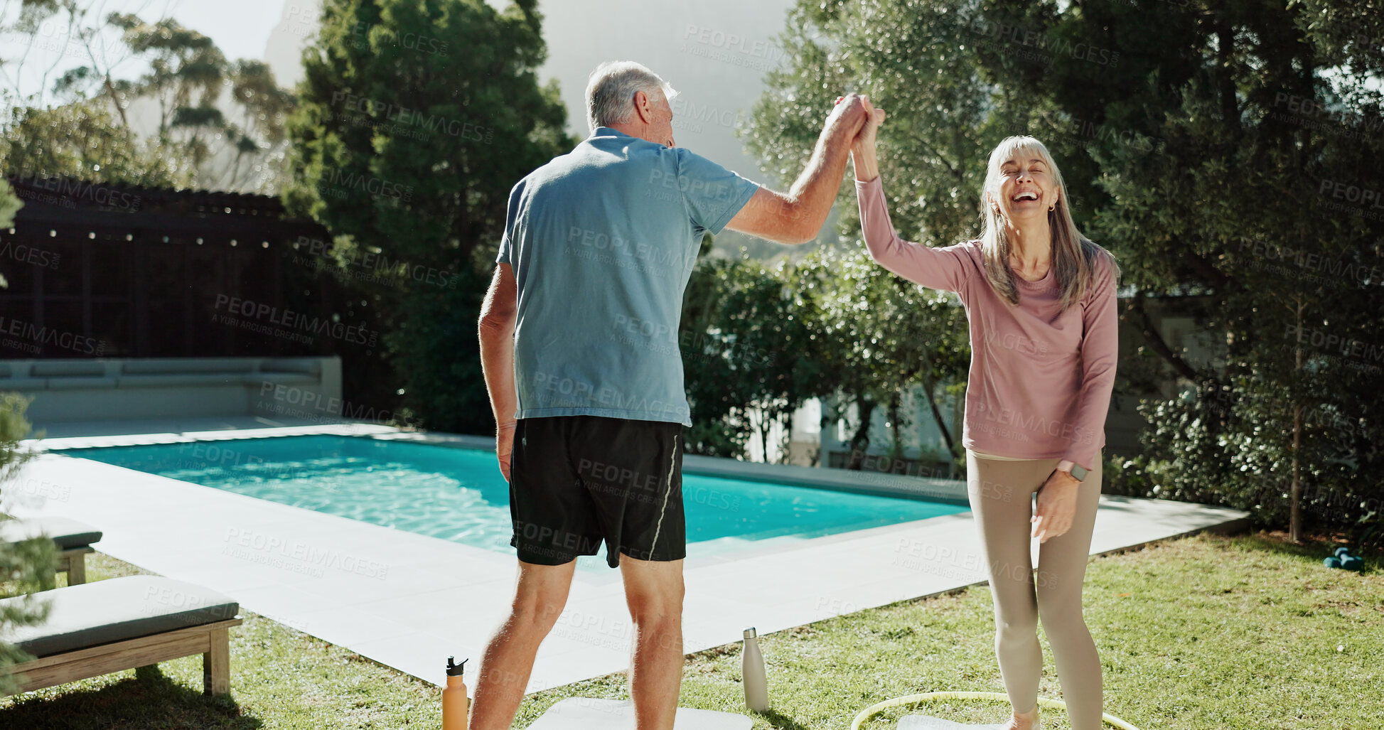 Buy stock photo Fitness, high five and old couple in garden, smile and bonding together for relationship, humor or love. Swimming pool, senior man and happy woman in backyard, goals and exercise for health benefits