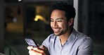 Night, man and smile in office with phone, journalist research and text message for story update. Late, person and typing in workplace with tech, check email and notification for feedback on article.