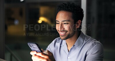 Buy stock photo Night, man and smile in office with phone, journalist research and text message for story update. Late, person and typing in workplace with tech, check email and notification for feedback on article.