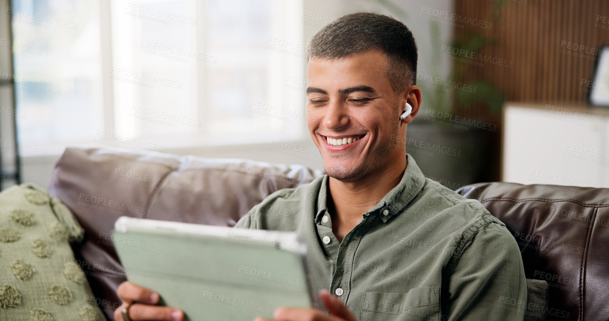 Buy stock photo Laugh, tablet and man on sofa with earphones for online videos, subscription and watching movies. Home, happy and person on digital tech for internet, website and streaming to relax on weekend