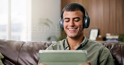 Buy stock photo Laugh, tablet and man on sofa with headphones for online videos, subscription and watching movies. Home, happy and person on digital tech for internet, website and streaming to relax on weekend