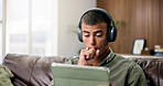 Surprise, tablet and man on sofa with headphones for online videos, subscription or watching movies. Home, shock and person on digital tech for internet, website and streaming drama series on weekend