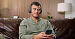 Man, phone and relax with headphones on sofa for streaming, smile and sound in living room at house. Person, smartphone and listen to music with subscription, mobile app or audio on couch in home