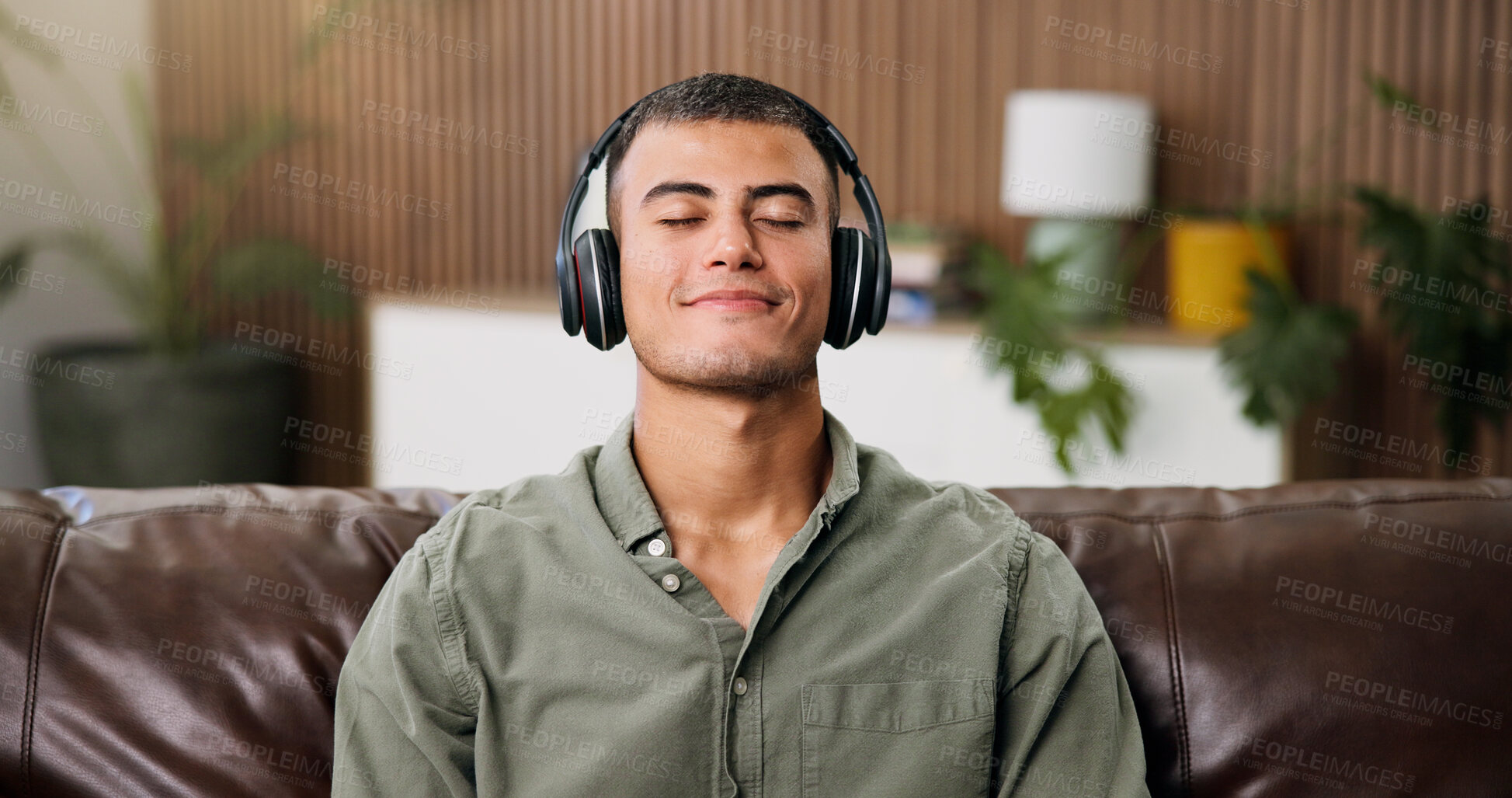 Buy stock photo Man, headphones and relax on sofa with audio streaming, chill and break on weekend in home. Male person, music and listening to song with eyes closed, reflection or podcast in house living room