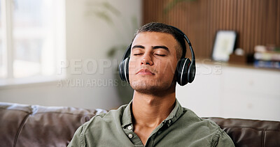 Buy stock photo Man, headphones and relax on sofa with streaming, chill audio and break on weekend in home. Male person, music and listening to song with eyes closed, reflection or podcast in house living room