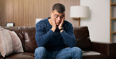 Buy stock photo Man, sad and thinking on sofa in home for reflection, stress or mental health in living room. Person with depression, frustrated or ptsd in lounge with regret, anxiety or remember trauma at apartment