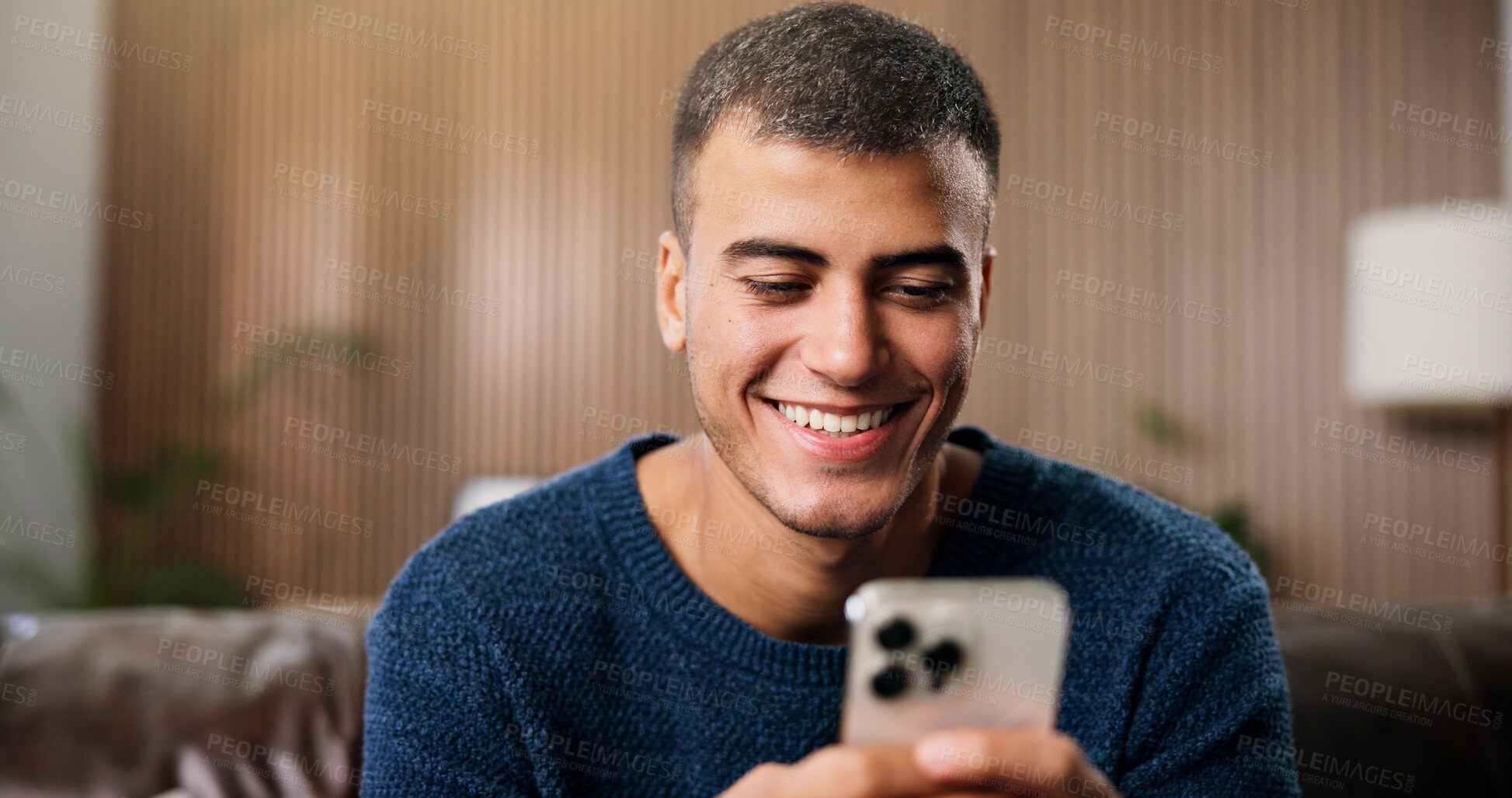 Buy stock photo Relax, happy and man in home with phone for social media, online dating and chat on weekend. Smile, house and person on smartphone for internet, connection and reading notification on mobile app