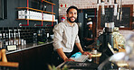 Man, business owner and happy in portrait at restaurant with confidence, pride and counter at cafe. Person, barista and smile at bar with cloth, catering and service for entrepreneurship at diner