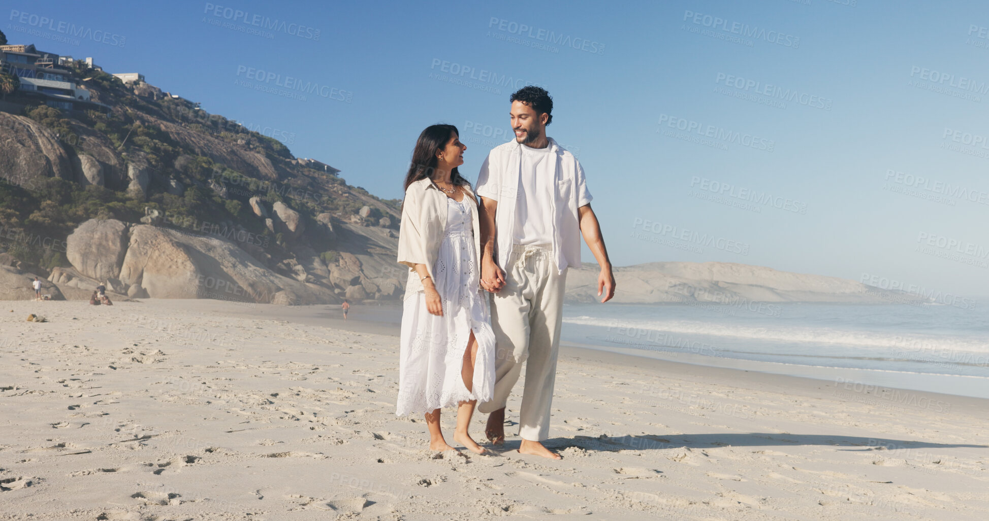 Buy stock photo Holding hands, smile and walking with couple on beach together for anniversary, date or honeymoon. Blue sky, sand and space with happy people outdoor in nature for holiday, travel or vacation