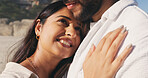 Chest, love and smile of couple on beach together for anniversary, date or honeymoon in summer. Holiday, travel and vacation with happy woman hugging man outdoor for bonding or relationship security