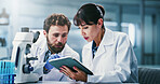 Microscope, science and tablet with people in laboratory together for development or research. App, feedback and talking with scientist team at work on clinical trial, medical industry or study