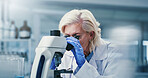 Lab, medical research and mature woman with microscope, biotech and disease diagnosis for healthcare. Clinic, scientist and person with equipment for cell analysis, innovation and histopathology