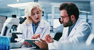 Buy stock photo Tablet, research and people in workplace, science and mentor with discussion for experiment. Scientist, man or woman in lab, coaching or biotech for medical review, talking or advice for breakthrough