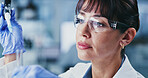 Scientist, woman and pipette in lab with test tube, DNA experiment or evaluation for medical research. Mature person, science or sample review in clinic with equipment, healthcare trial or innovation