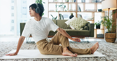 Buy stock photo Headphones, stretching and yoga with Asian man in home living room for exercise or wellness routine. Fitness, health and music with yogi person on floor in apartment for balance or holistic activity