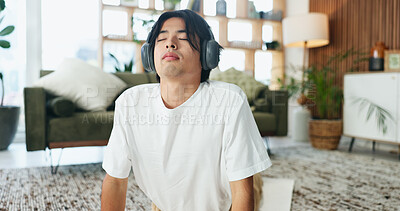 Buy stock photo Headphones, stretching and yoga with man on floor in home living room for exercise or wellness routine. Fitness, health and music with Asian yogi person in apartment for balance or holistic activity