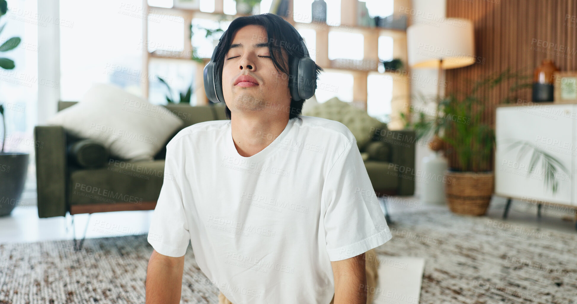 Buy stock photo Headphones, stretching and yoga with man on floor in home living room for exercise or wellness routine. Fitness, health and music with Asian yogi person in apartment for balance or holistic activity