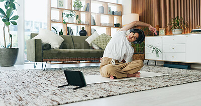 Buy stock photo Stretching, tablet and yoga with Asian man in home living room for exercise or wellness routine. App, fitness and headphones with yogi person on floor in apartment for online class or tutorial