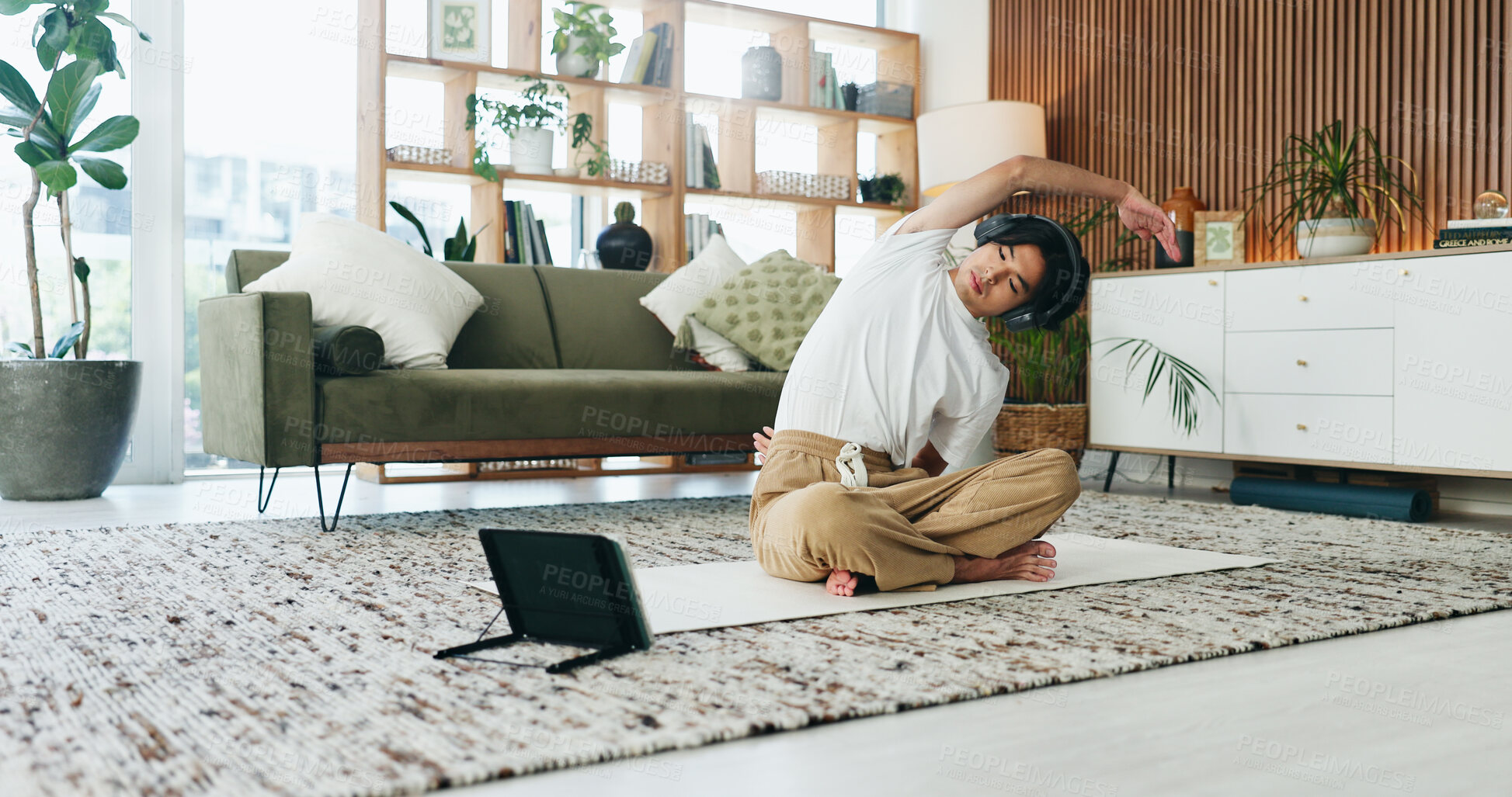Buy stock photo Stretching, tablet and yoga with Asian man in home living room for exercise or wellness routine. App, fitness and headphones with yogi person on floor in apartment for online class or tutorial